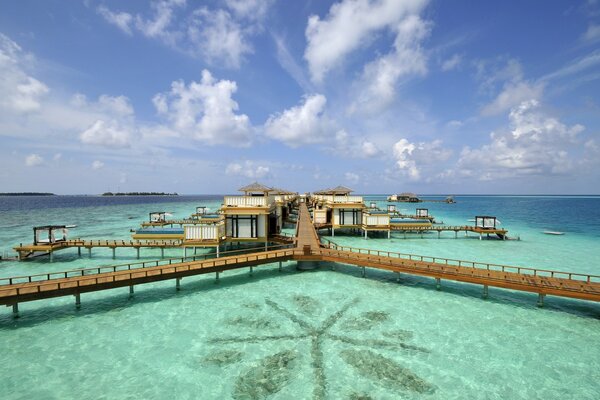 Mer turquoise et ponts en bois aux Maldives