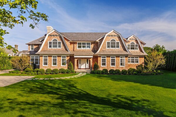 A large house on a manicured lawn