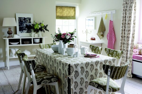 A set table in the dining room in white and green tones