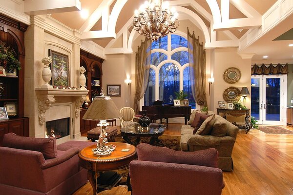 The interior of the living room with furniture and a huge chandelier