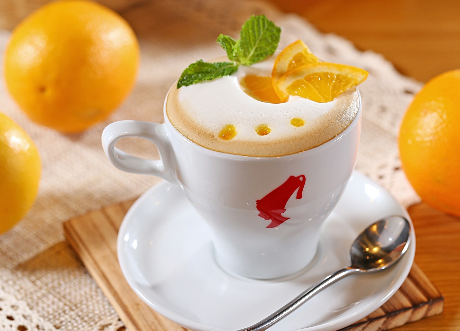 citrus saucer white fruits orange foam bed milk spoon coffee segments cup