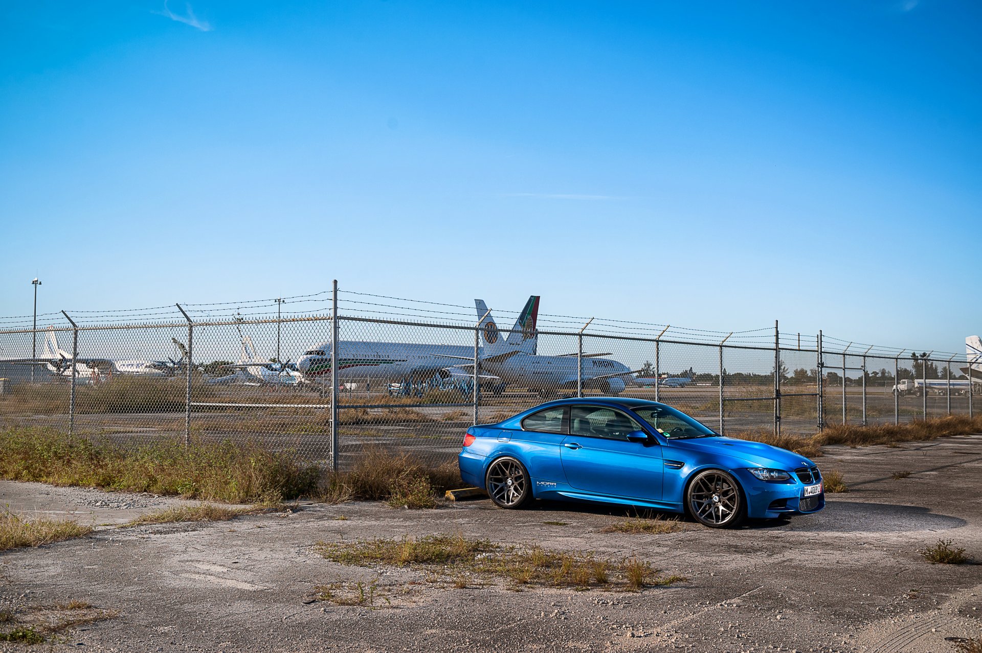 bmw m3 e92 blue bmw side view fence barbed wire