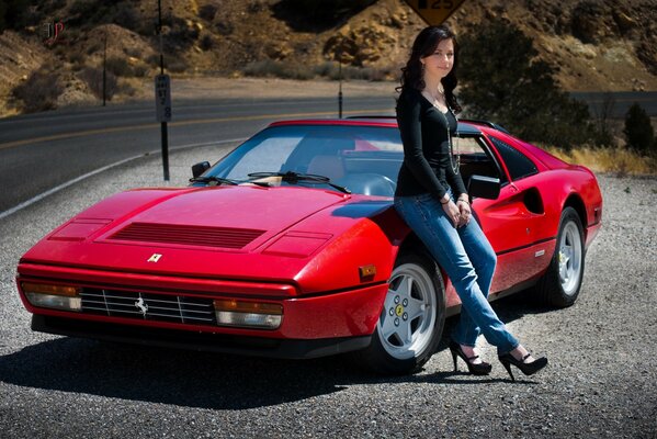 The girl is sitting on a red Ferrari 328