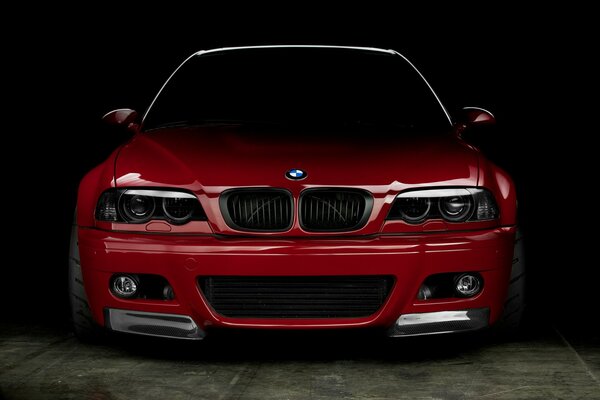 A predatory red BMW peeks out of the darkness