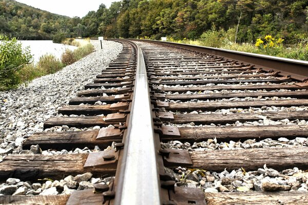 Railway along the river with nature and stones