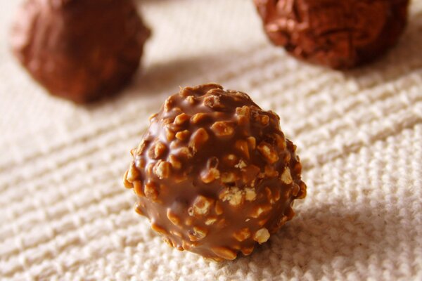 Chocolate candies with nut sprinkles