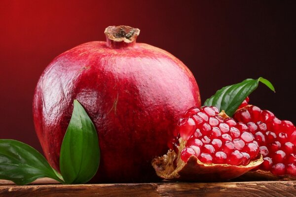 Juicy, red, overripe pomegranate in still life