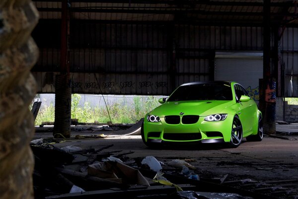 Bmw m3 e92 green stands in an abandoned hangar