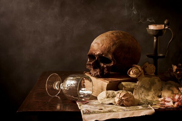 Still life with a glass, candle and skull