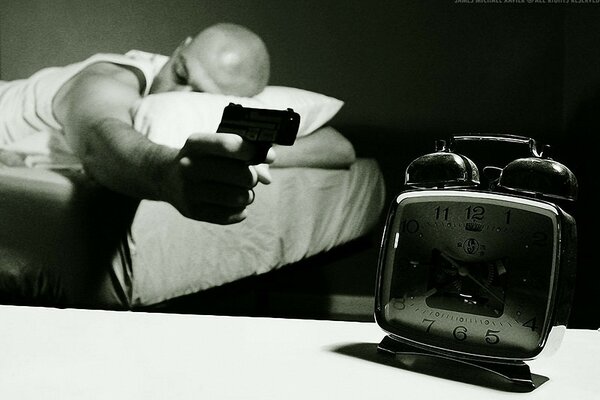 The alarm clock is muted with a pistol and sleeps on