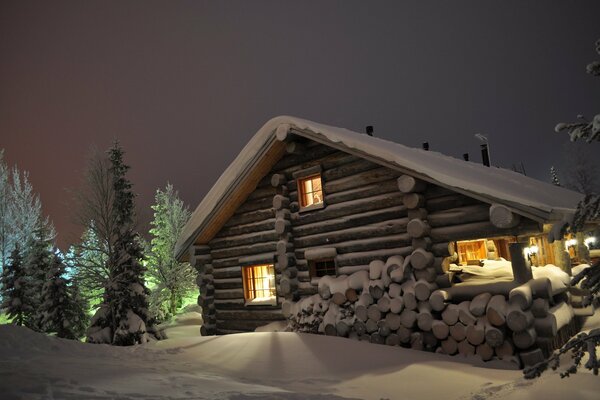 A house on a winter night with light in the windows