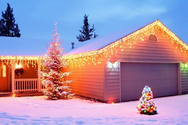 Verschneites Neujahrshaus und Weihnachtsbaum