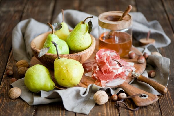 Spoon in honey with nuts pears and ham