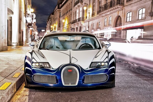 Luxury bugatti and the lights of the evening city