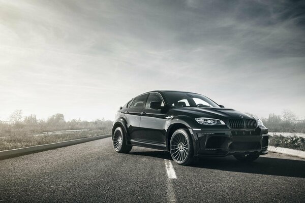 L auto nera bmw x6m guida sulla strada