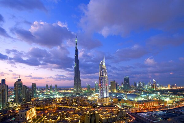 Clouds in the sky over Dubai and the skyscrapers of the night city