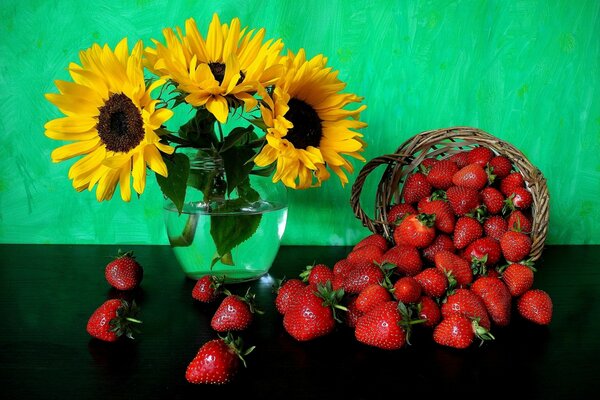 Stillleben von Erdbeeren in einem Korb und Sonnenblumenblüten