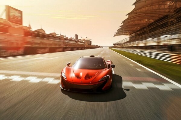 On the track at full speed - tomato-colored McLaren