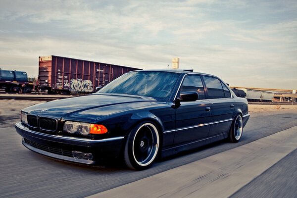 Blue bmw 740i on the way to the train station