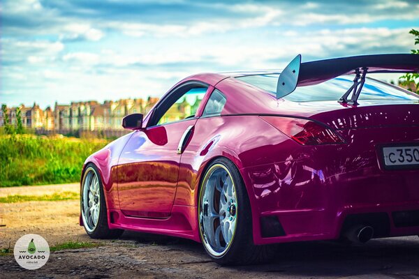 Pink Nissan 350z on the background of the city