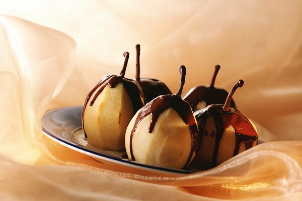 A plate with a dessert of chocolate-covered pears