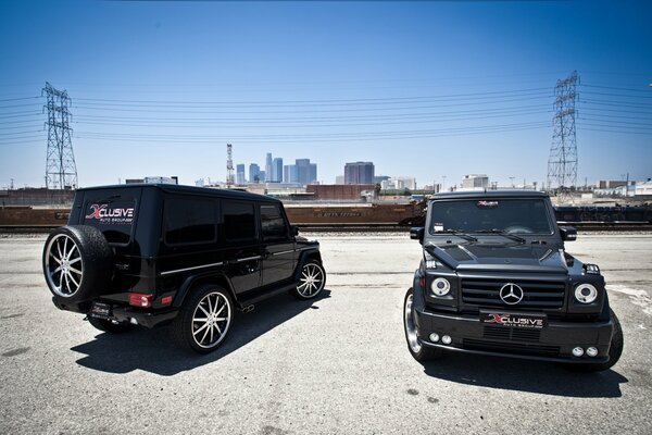 Two black Mercedes SUVs in the parking lot