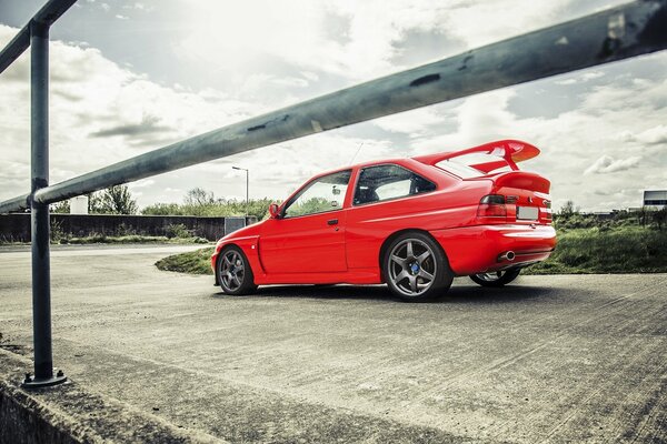 Red Ford on a rainy sky background