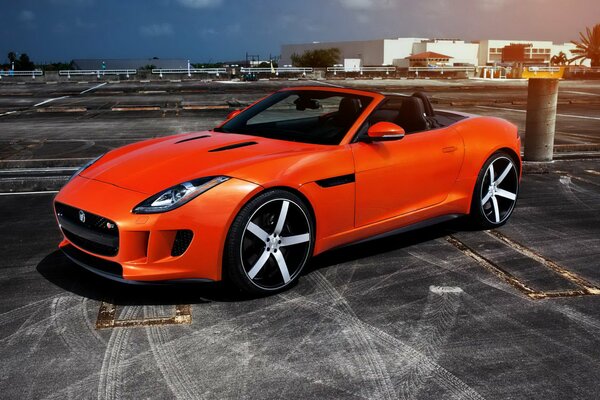 Red jaguar roadster in the parking lot