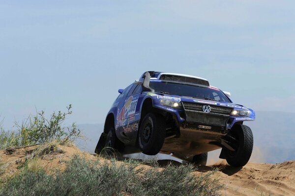 Blue SUV driving off-road