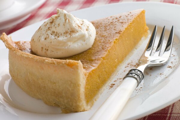 Meringue pie on a plate with a fork