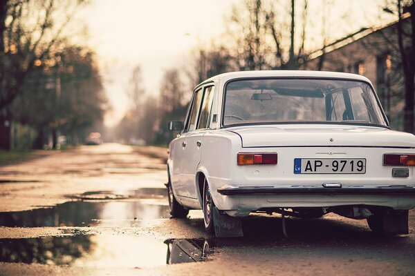 The white lada kopek stands on the autumn road