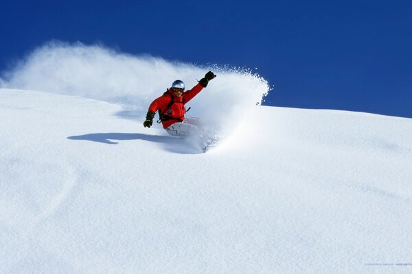 Snowboarder schneidet die schneebedeckte Fläche ab