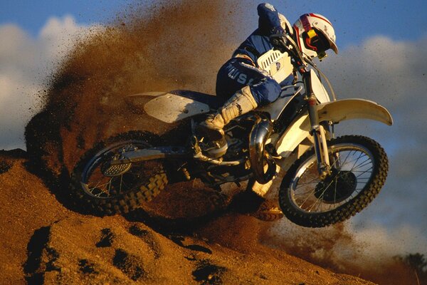 Motorcyclist s drift along the earthen road