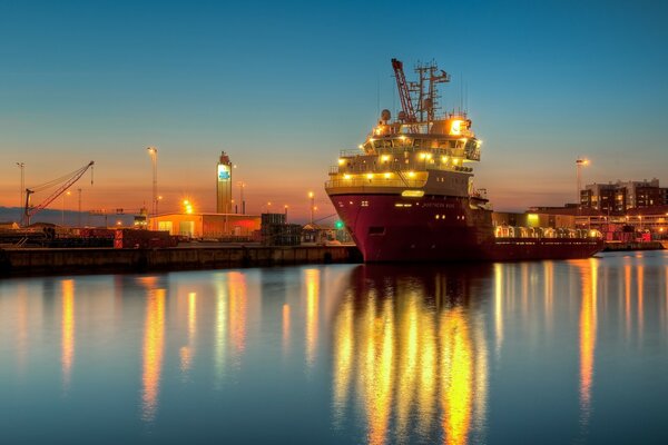 A barge at the pier in the night light