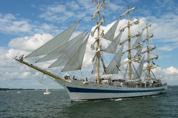 A white sailboat sails on the sea