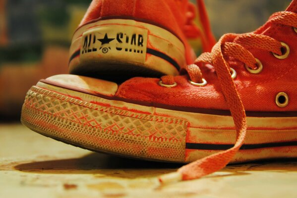 Scarlet sneakers with red laces and a star