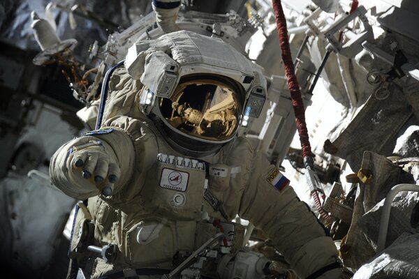 Russian astronaut in spacesuit open space