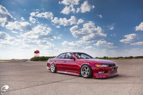 A tuned red Toyota on the road