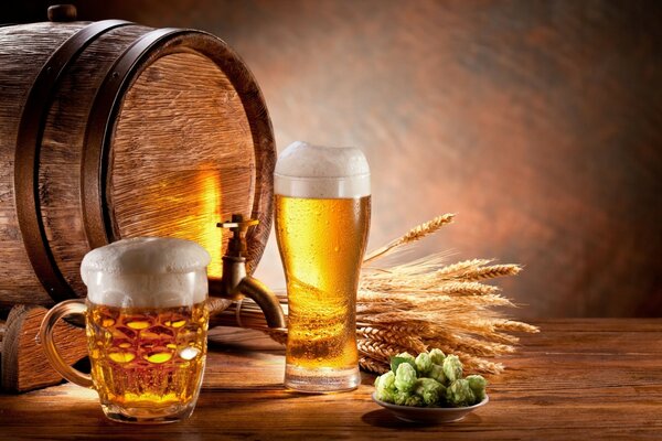 Wooden barrel, hops and beer mugs