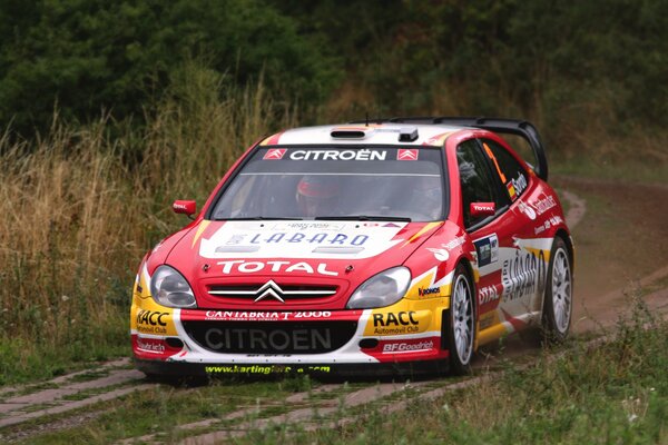 Rally Citroen with advertising on the hood and sides at the race