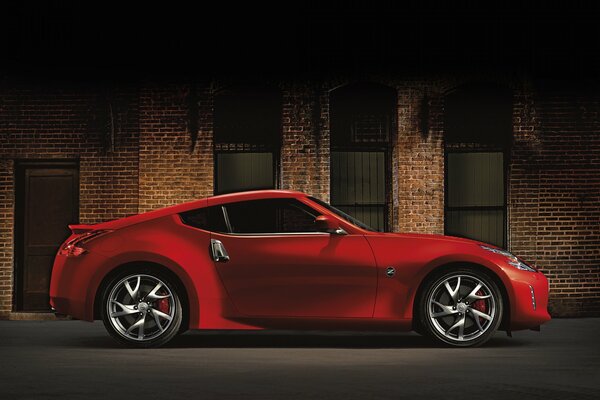 Red sports car on the background of a brick building