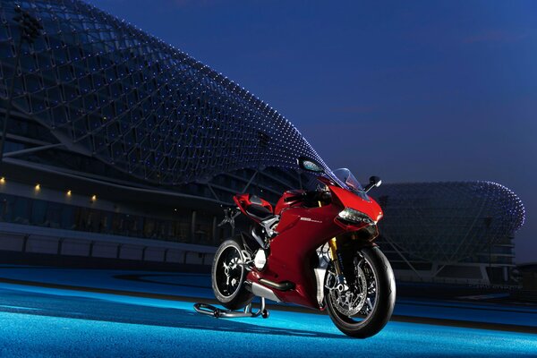 Ducati red sport bike at the night stadium