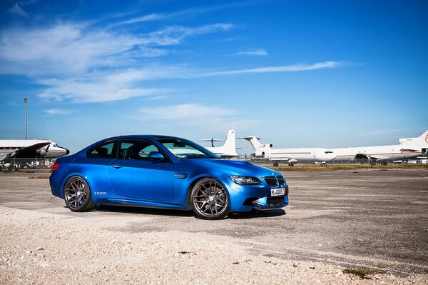 Blue BMW on the runway of the aerodrome