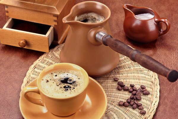 A cup of coffee next to a turk on a round napkin