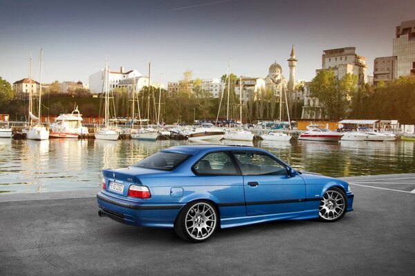 BMW troika on the embankment, against the background of yachts