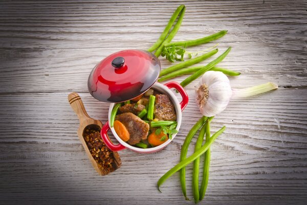 Delicious meat with beans in a saucepan