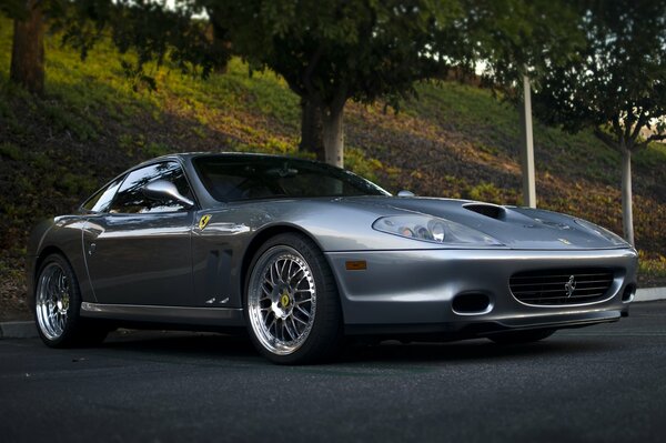 Silver Ferrari 575 maranello among the trees