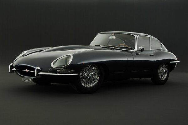 Retro photo of a black Jaguar car on a black background