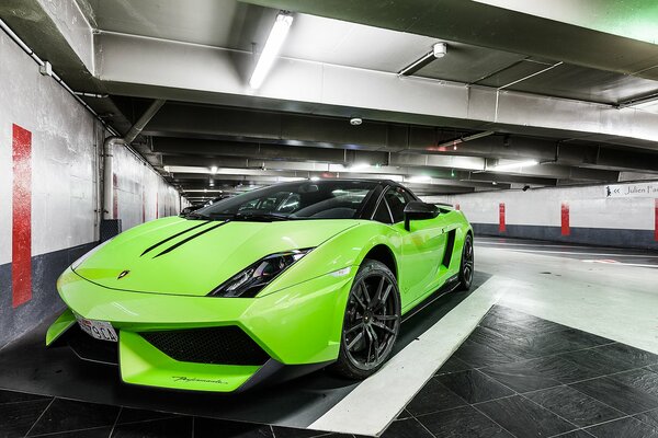 A light green Lamborghini is parked in the hangar