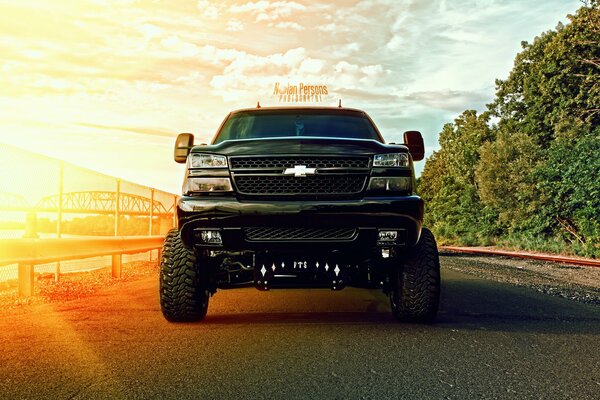 Chevrolet in the sun on the background of the road